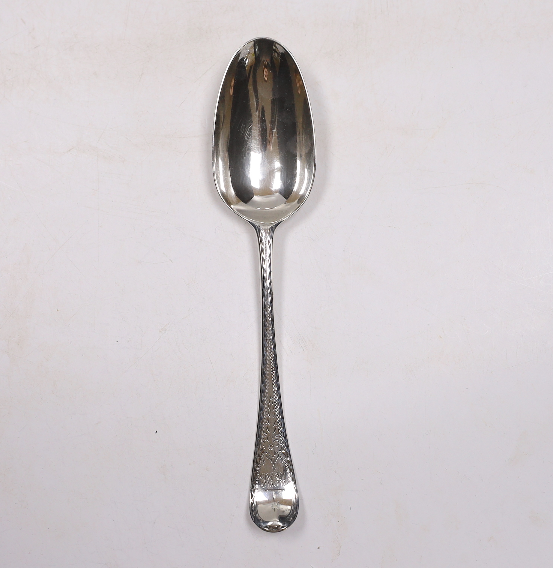 A late George II? bright cut engraved base mark table spoon, marks pinched and rubbed, 20.3cm, 64 grams.
